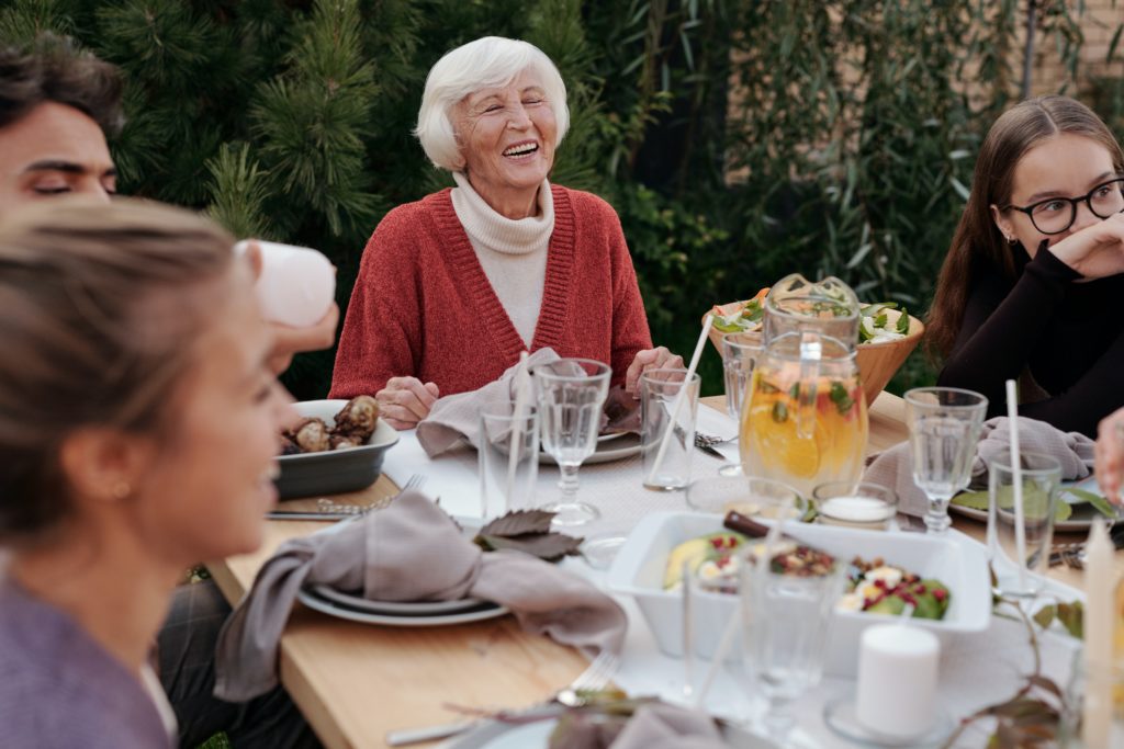 older woman eating dinner with family