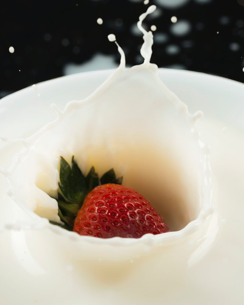 strawberry splashing in milk.