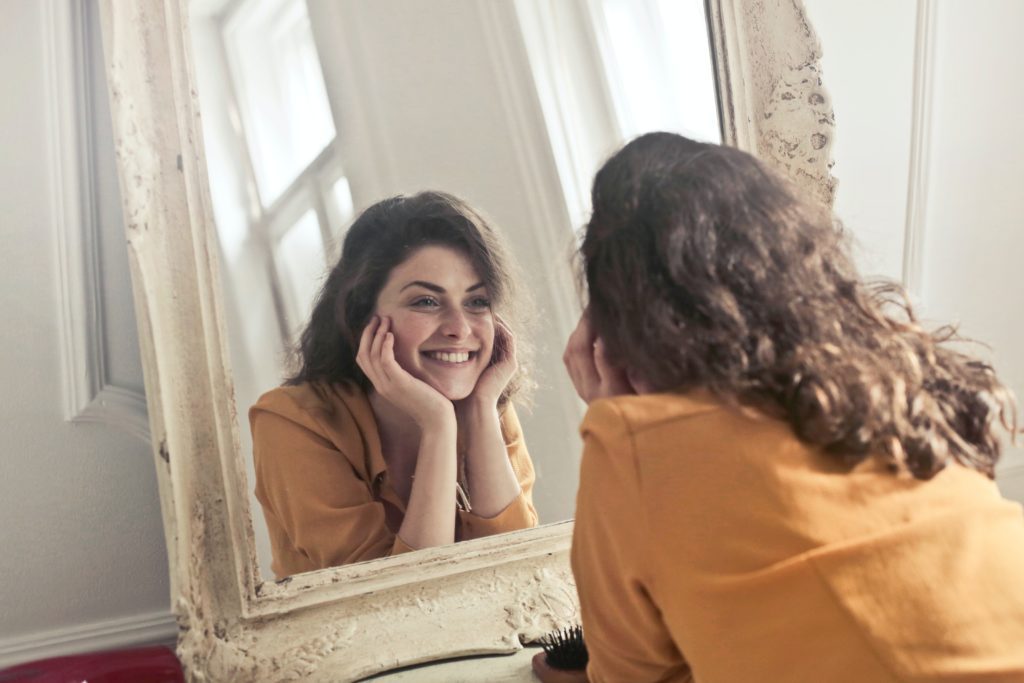 positive affirmations while looking in mirror.