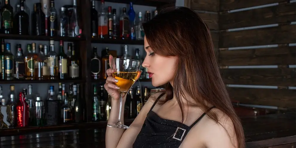woman drinking cocktail.